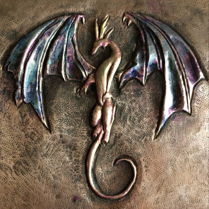 Metallic dragon emblem on a textured bronze surface