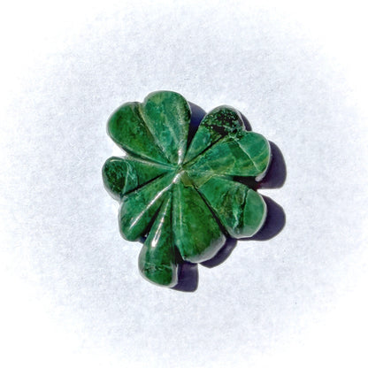 Green stone with a leaf-like pattern on a white background